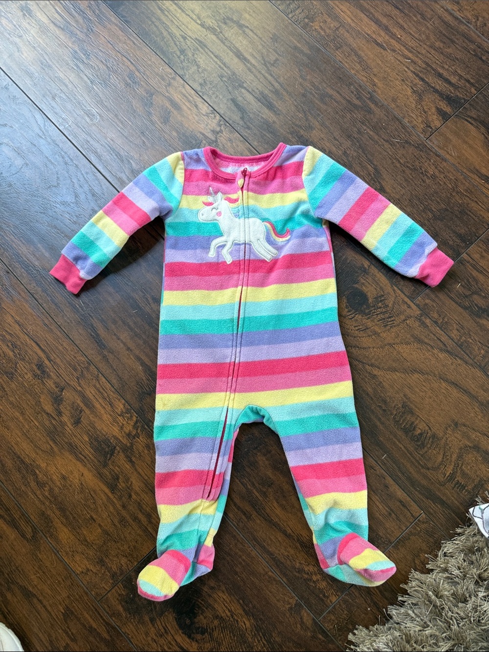 Pink striped pajama onesie with unicorn rainbow